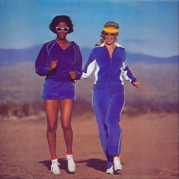 Velour cover: two women in vintage purple athletic wear on a desert road